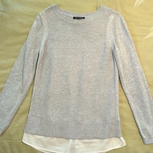 Light gray ribbed sweater blouse trim at bottom in white.